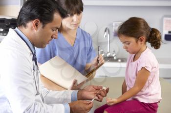 Doctor Giving Child Injection In Doctor's Office