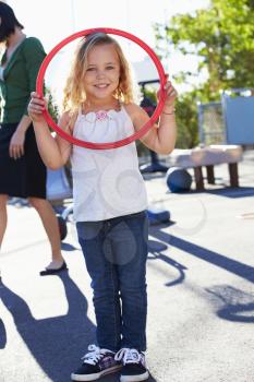 Girl In School Playground With Hoop