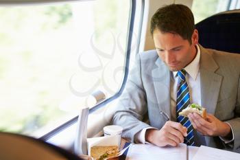 Businessman Eating Sandwich On Train Journey