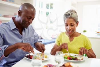 Mature African American Couple Eating Meal At Home