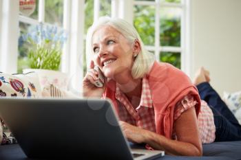 Middle Aged Woman Ordering Item On Telephone