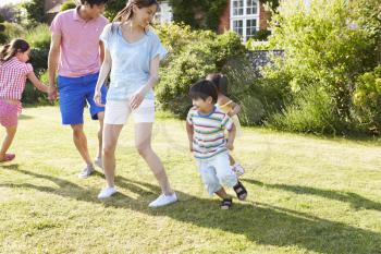 Asian Family Playing In Summer Garden Together