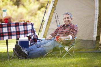 Man Enjoying Camping Holiday In Countryside