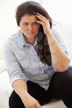 Depressed Overweight Woman Sitting On Sofa