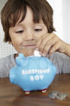 Young boy with piggy bank