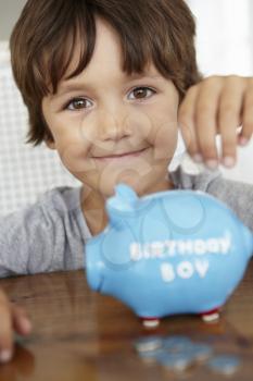 Young boy with piggy bank