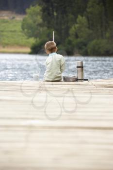Young boy fishing on a jetty