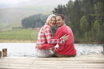 Romantic couple sitting on a jetty