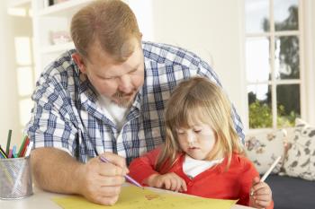 Father and Downs Syndrome daughter drawing