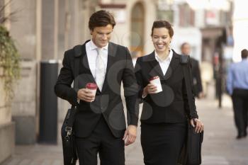 Businessman and businesswoman on their way to work