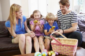 Family With Easter Eggs At Home