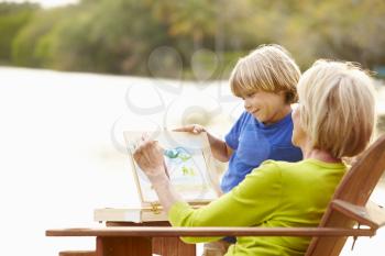 Grandmother With Grandson Outdoors Painting Landscape