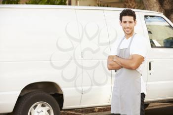 Man Wearing Apron Standing In Front Of Van