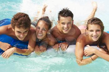 Group Of Teenage Friends Having Fun In Swimming Pool