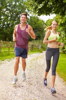 Couple On Run In Countryside Together