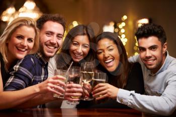 Group Of Friends Enjoying Evening Drinks In Bar