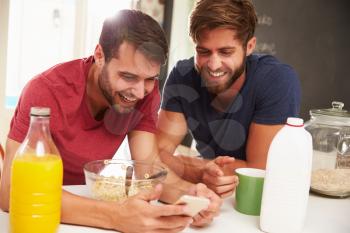 Two Male Friends Having Breakfast And Reading Text Message