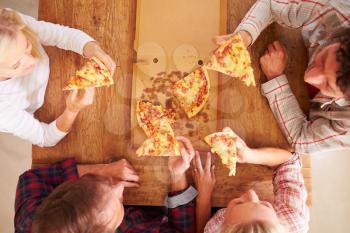 Friends sharing a pizza together, overhead view