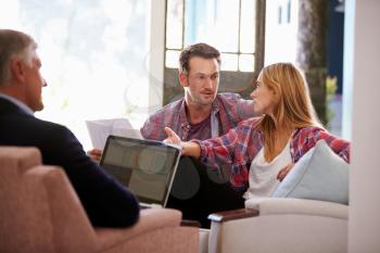 Couple At Home Meeting With Financial Advisor