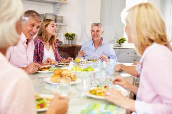 Group Of Friends Enjoying Meal At Home Together
