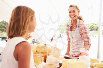 Woman Selling Fresh Cheese At Farmers Food Market
