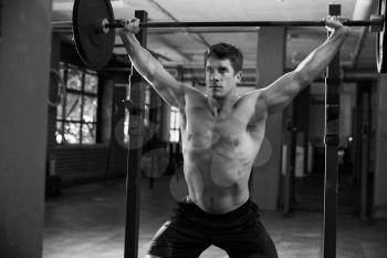 Black And White Shot Of Man In Gym Lifting Weights