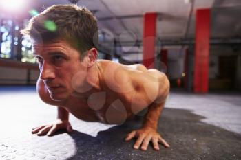 Bare Chested Man In Gym Doing Press-Ups
