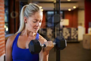 Woman In Gym Lifting Hand Weights
