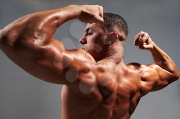 Male bodybuilder flexing his biceps