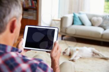 Close Up Of Man Using Digital Tablet At Home