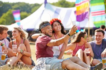 Friends taking selfie at a music festival