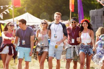 Group of friends walking through a music festival site