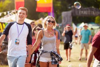 Couple walking through music festival
