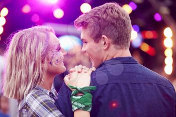Couple looking at each other in the crowd at music festival