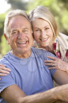 Portrait Of Senior Couple Relaxing In Countryside