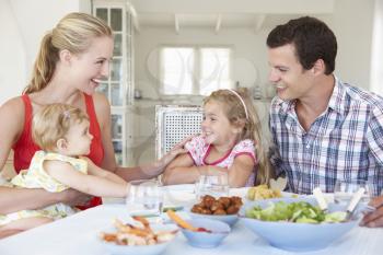 Family Enjoying Meal Together At Home