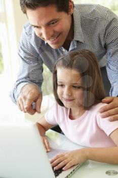 Hispanic Father And Daughter Using Laptop