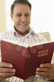 Senior Hispanic Man Reading Bible