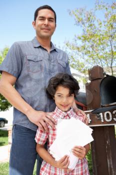 Hispanic Father And Son Checking Mailbox