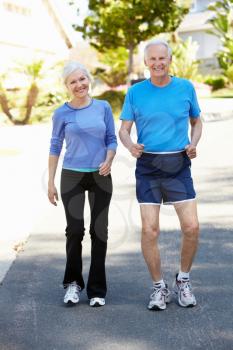 Elderly man and younger woman jogging