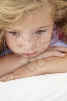Young Girl Looking Sad On Bed In Bedroom