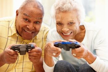 Senior couple playing computer games