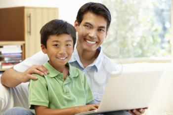 Father and son using laptop