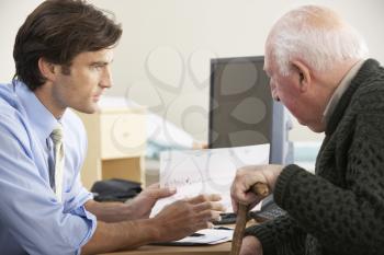 Doctor talking to senior male patient