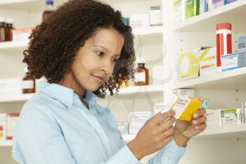 Female pharmacist working in UK pharmacy
