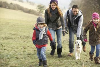 Family and dog having fun in the country in winter
