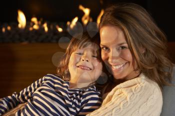 Portrait mother and son by firelight
