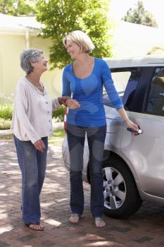 Woman Helping Senior Woman Into Car