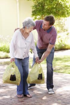 Man Helping Senior Woman With Shopping