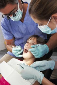 Dentist And Nurse Giving Girl Check Up